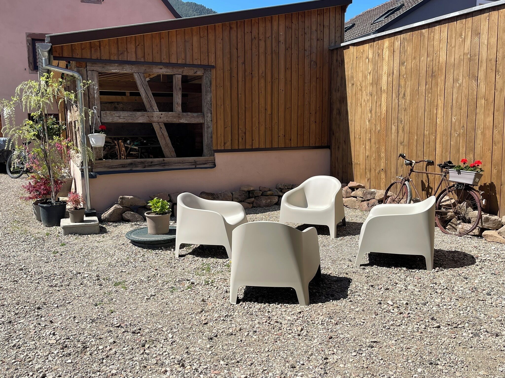 A patio area with outdoor furniture and potted plants.