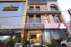 A hotel with a sign for 'Stay Spire Hotel' and a 'Bigg Gorilla Restro & Cafe' above it. - Hotel Stayspire (Indore)
