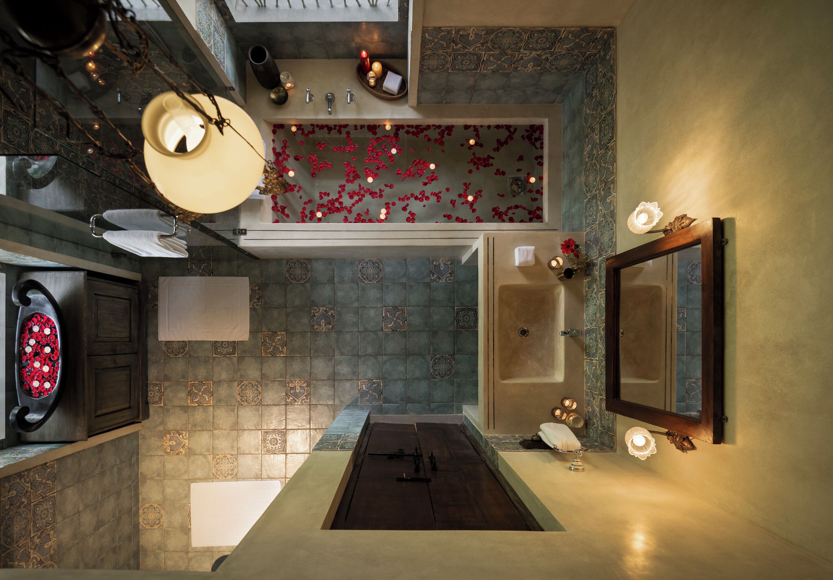 A bathroom with a bathtub, a large mirror, and a shower area.