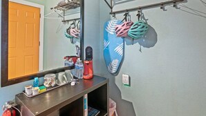 A bathroom with a mirror, a towel rack, and a shelf with toiletries. - Dive Into the 50s- Restored Motel in St Augustine (St. Augustine)