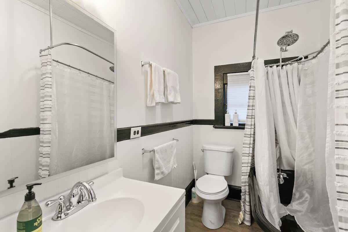A bathroom with a bathtub, toilet, and sink.