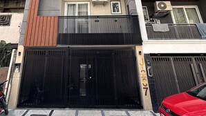 A multi-story residential building with balconies, air conditioning units, and a gated entrance. - Fortune Home Service Apartment Studio, J-267 Saket (New Delhi)