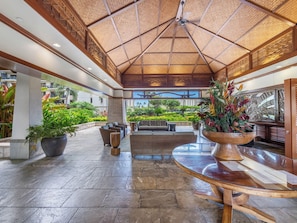A spacious lobby with a high ceiling, large potted plants, and a view of the surrounding greenery. - Beach Villas Oceanfront Resort at Ko Olina w/Unobstructed Views (Kapolei)