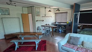 A compact living space with a kitchenette, a dining area, and a sofa. - Modern and Cozy Rustic Loft (Puerto Vallarta)