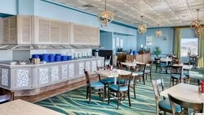 A restaurant with a bar area, multiple tables, chairs, and a patterned carpet. - Our beautiful, one bedroom beachfront condo (sleeps 6) has spectacular views of the Atlantic Ocean from the 17th floor! Newly updated in December 2025 (Myrtle Beach)