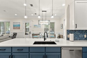 A modern kitchen with a large island, pendant lighting, and a dishwasher. - August 1-5 Now Open*Golf Cart* Great Pool Putting Green*Beach Access*Grill*Patio (Miramar Beach)