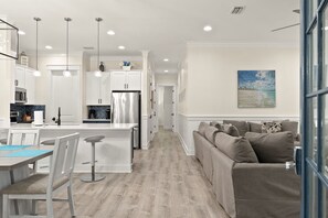 A modern kitchen with white cabinetry, a central island, and pendant lighting. - August 1-5 Now Open*Golf Cart* Great Pool Putting Green*Beach Access*Grill*Patio (Miramar Beach)