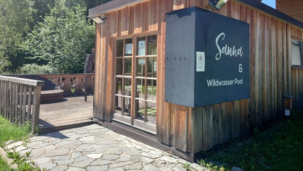 Un edificio de madera con un letrero que dice 'Sundh & Wildwaser Pool'.