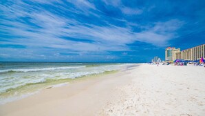 A beach with a hotel in the background. - Phoenix V 1516 2 Bedroom Condo (Orange Beach)