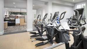 A gym with treadmills, a reception area, and a kitchen/lounge area. - Windermere Coastal Retreat 7c 2 Bedroom Condo (Myrtle Beach)