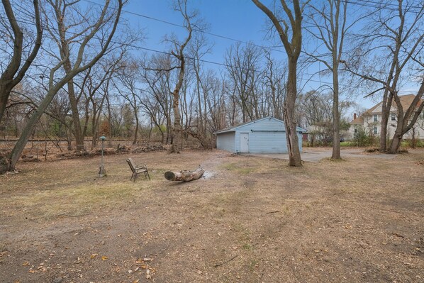 A rural property with a small shed, open space, and leaf-covered ground. - Spacious 2BR Across from Como Lake - Bramble (Saint Paul)