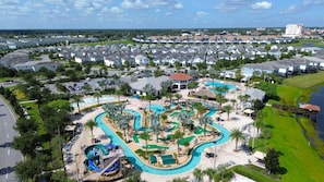 A resort with a large swimming pool, a water slide, and a golf course. - Storey Lake brand new near Disney lake & club view (Kissimmee)