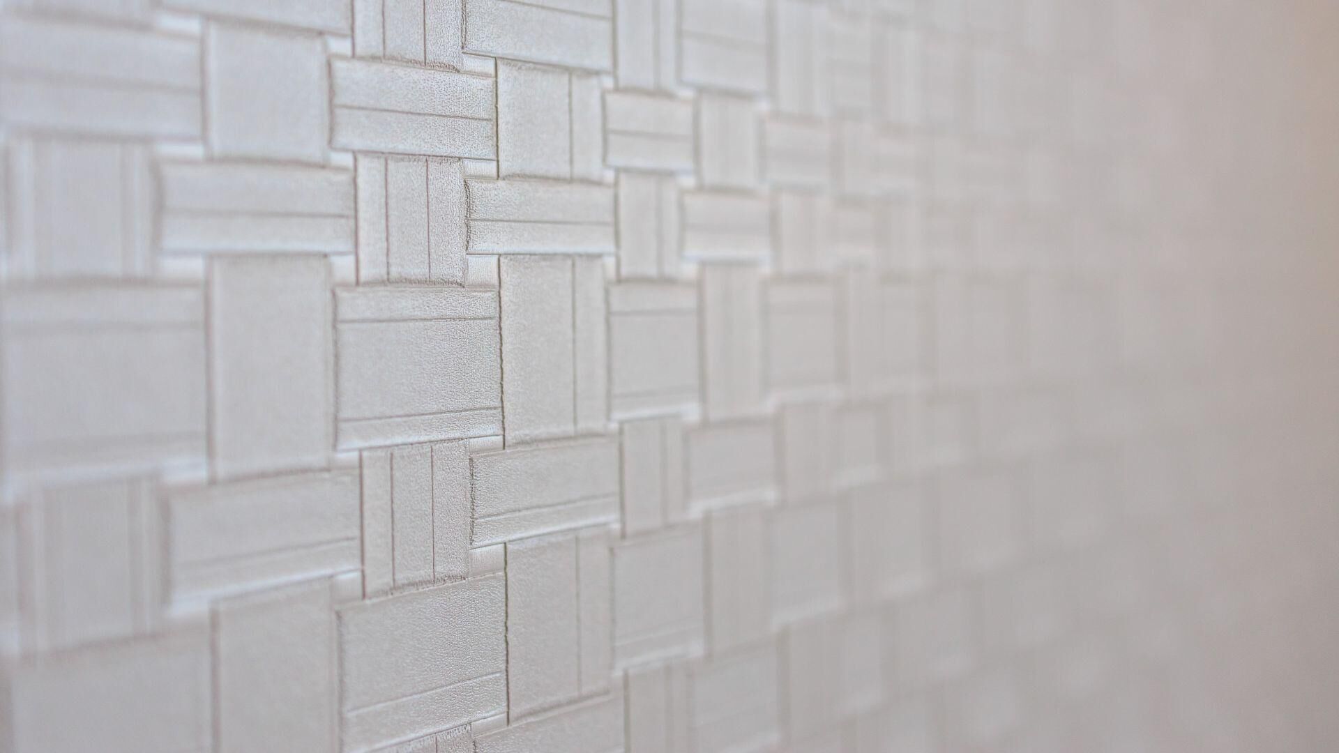 Een close-up van een met baksteensteenpatroon bewerkte muur.