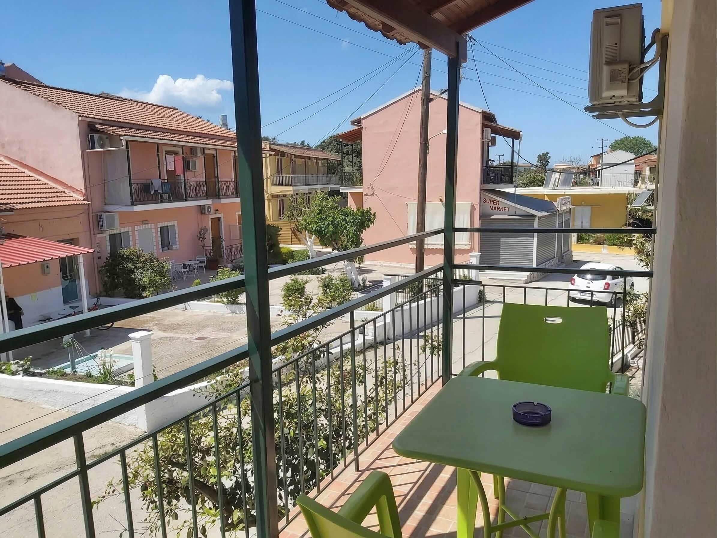Sunny private balcony with neighborhood views and outdoor seating