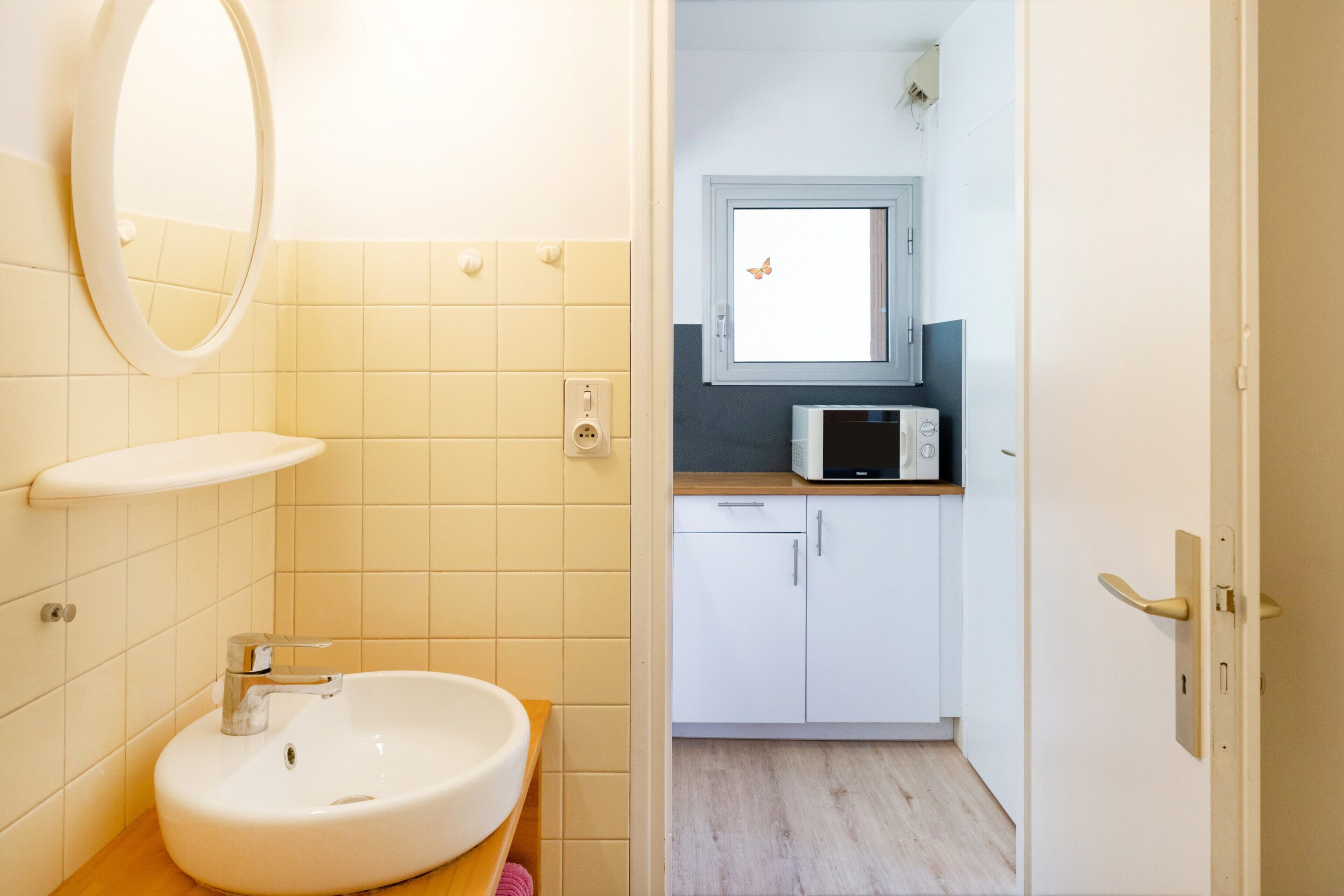 A bathroom with a sink, mirror, and toilet.