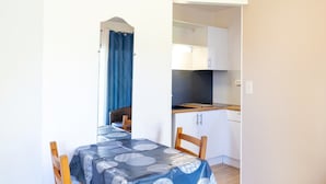 A small kitchenette with white cabinets and a countertop.