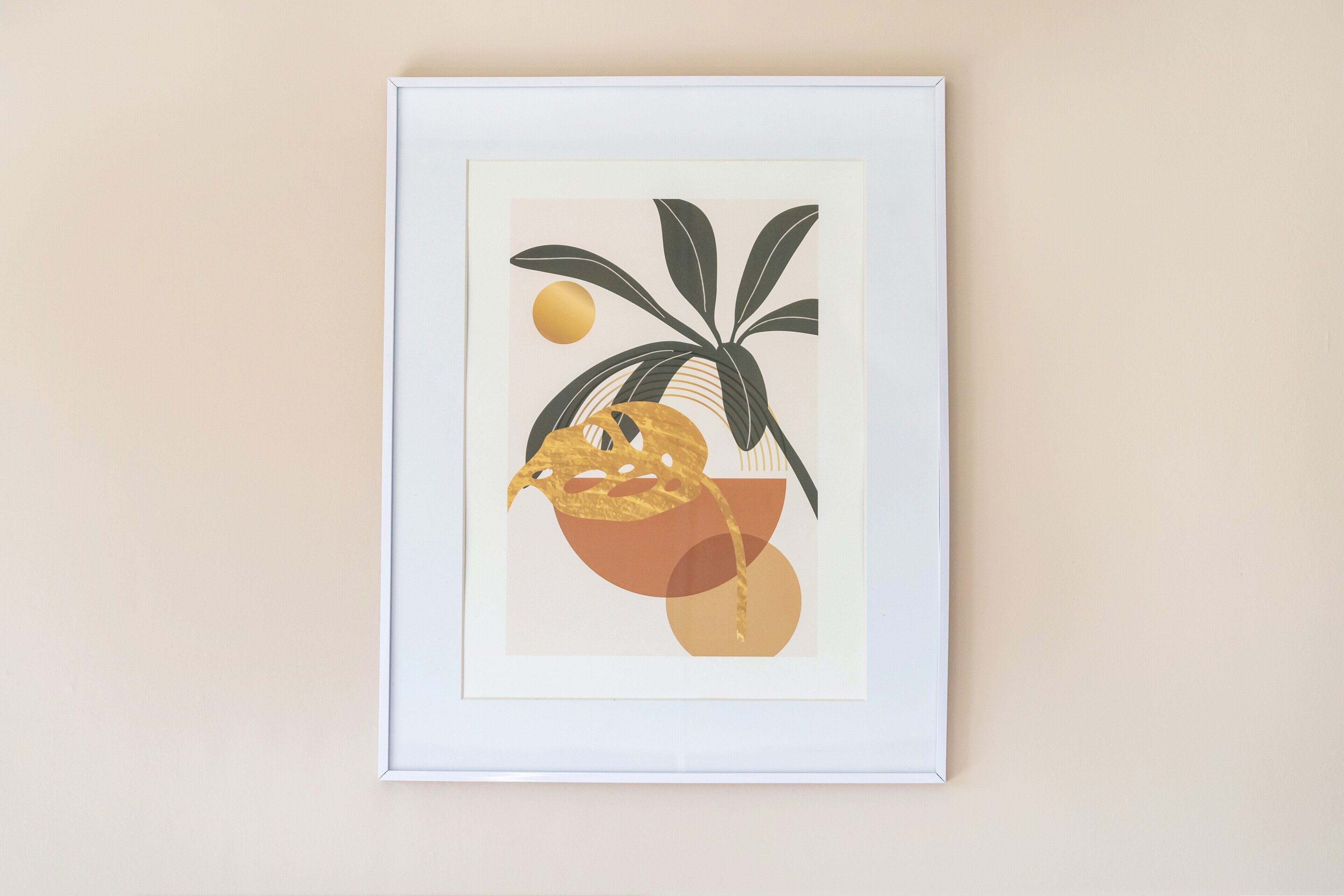 A framed artwork with abstract plant and fruit designs.