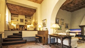 A spacious living area with a staircase, a fireplace, and a television. - Villa Casale Belvedere by Interhome (Monsummano Terme)