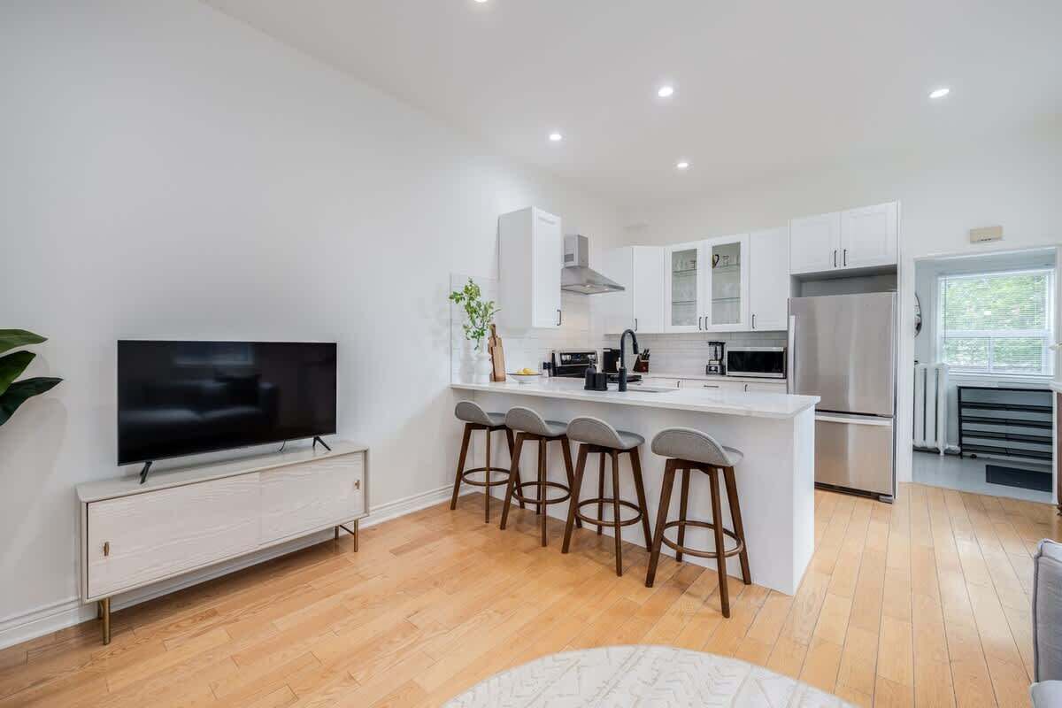 Expansive living space featuring a comfortable sofa and a smart TV for easy access to your Netflix or YouTube