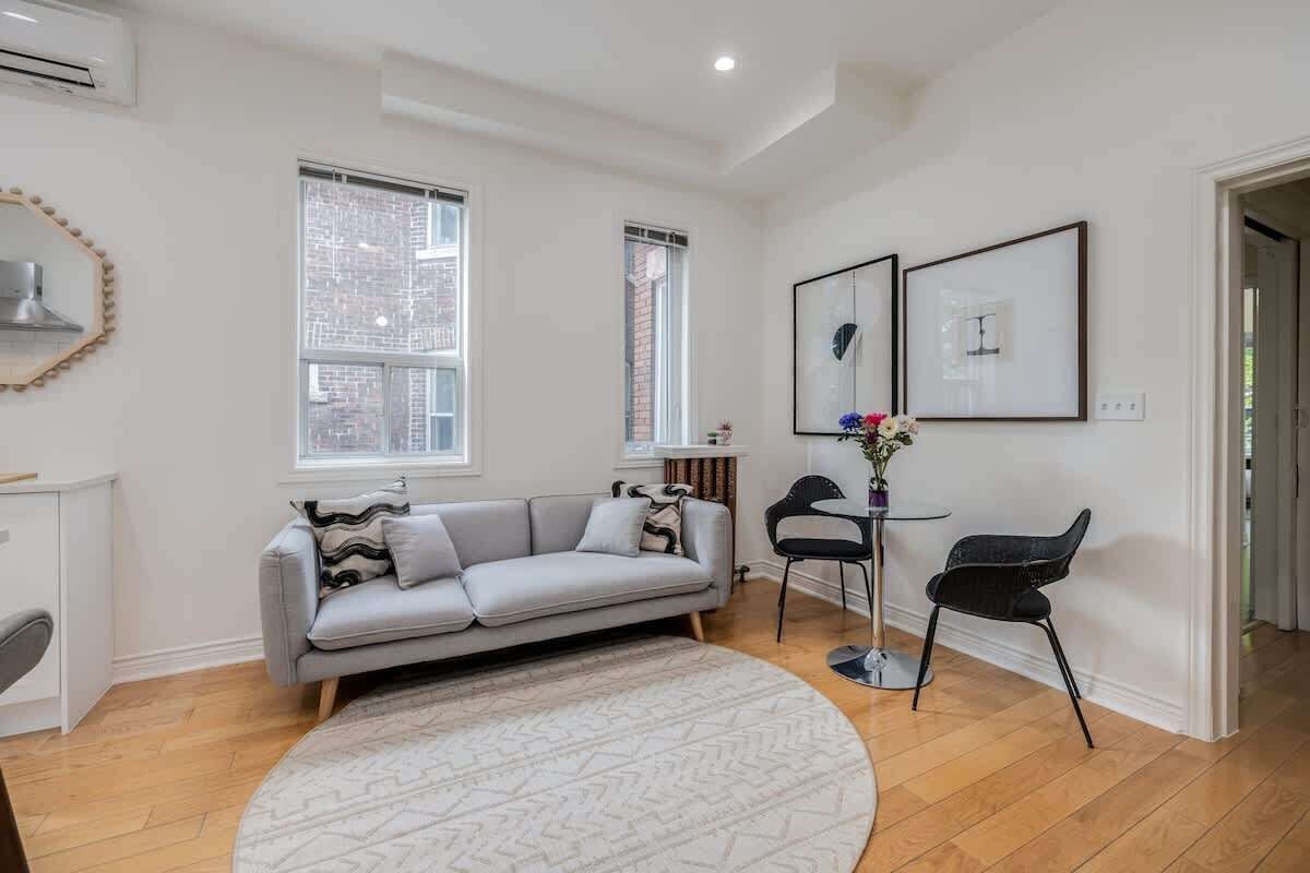 Expansive living space featuring a comfortable sofa and a smart TV for easy access to your Netflix or YouTube