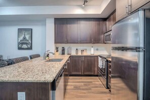 Fully equipped kitchen with all the essentials and modern appliances. - Cozy 1BR Downtown Stay with Balcony Views (Toronto)