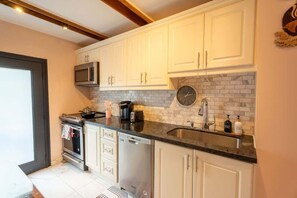 Fully equipped kitchen with modern appliances for all your cooking needs. - Stylish 2BR Home with Front Yard & Free Parking (Toronto)