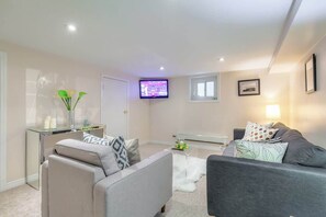Relax and unwind in one of two cozy living spaces, perfect for movie nights or laid-back mornings. - Cozy 3BR Home | 2Kitchens + Backyard | Leslieville (Toronto)