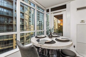Enjoy meals at a sleek 4-seater marble dining table, perfect for breakfast or a late-night bite. - Downtown Urban Oasis I Entertainment District (Toronto)