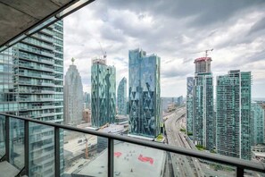 Step out onto your private balcony with stunning city & arena views. - Downtown 2BR condo w/ city views & free parking (Toronto)