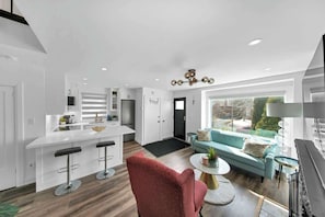Relax in a cozy living space with plush seating & a 65” Smart TV. - Hidden 3BR Gem w/ Workspace, Fast wifi & Parking! (Toronto)