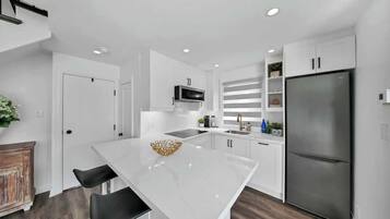 Fully stocked kitchen with modern appliances for all your cooking needs.