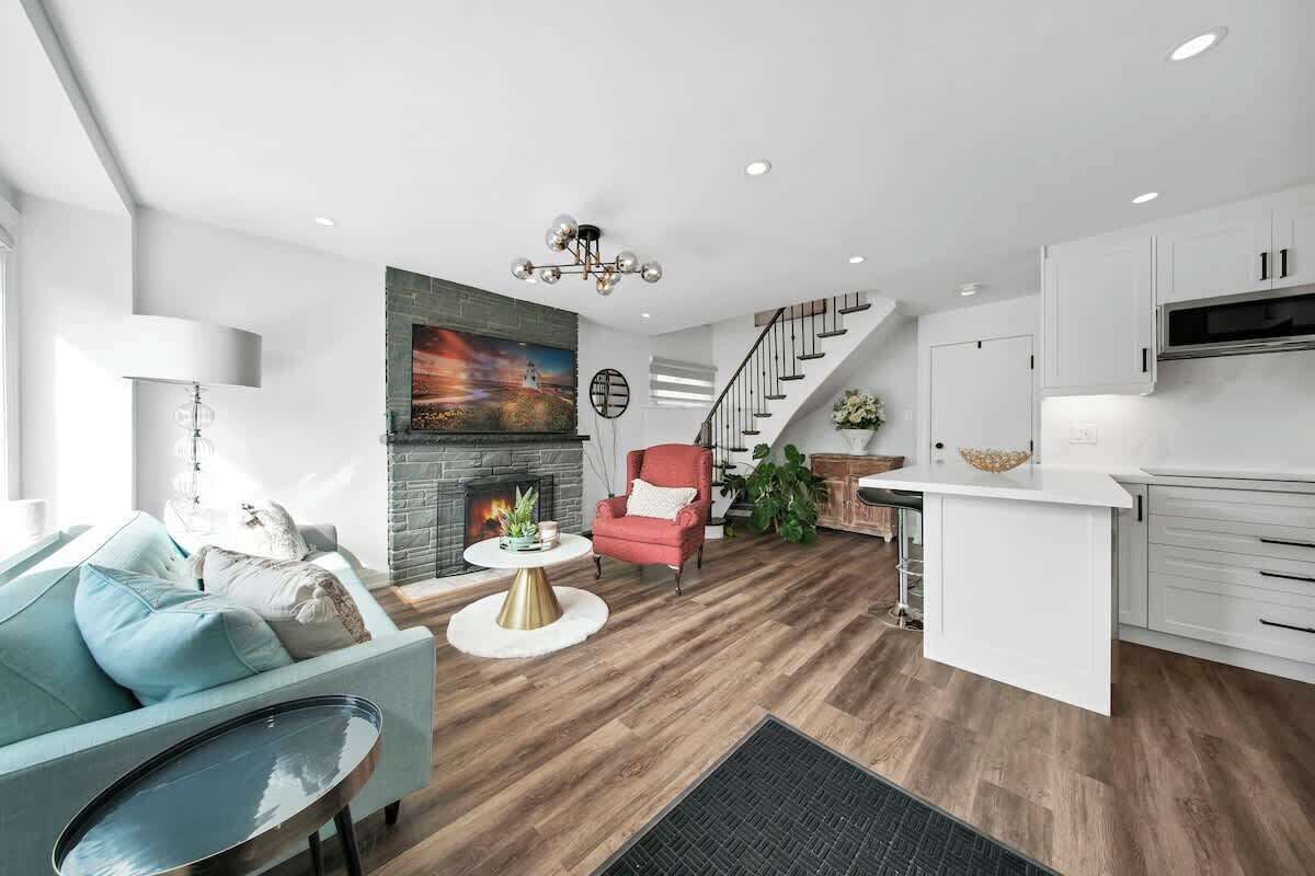 Relax in a cozy living space with plush seating & a 65” Smart TV.