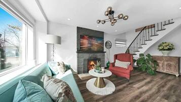 Relax in a cozy living space with plush seating & a 65” Smart TV.