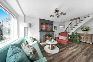Relax in a cozy living space with plush seating & a 65” Smart TV. - Hidden 3BR Gem w/ Workspace, Fast wifi & Parking! (Toronto)