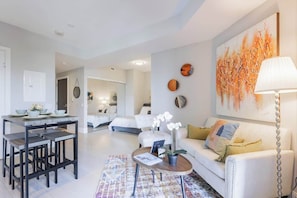 Relax in the cozy living space with comfortable seating and a warm, modern vibe. - Modern Downtown Toronto Condo near CN Tower (Toronto)