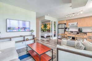 Relax in the cozy living area, perfect for unwinding after a day of exploring. - Chic 1BR+Den Condo | Fast WiFi & Free Parking (Toronto)