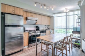 Cook with ease in the fully equipped kitchen—complete with modern appliances and cookware. - Chic 1BR+Den Condo | Fast WiFi & Free Parking (Toronto)