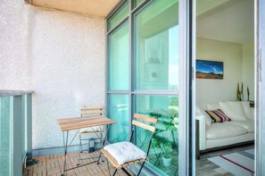 Step out onto the private balcony for fresh air  - Chic 1BR+Den Condo | Fast WiFi & Free Parking (Toronto)