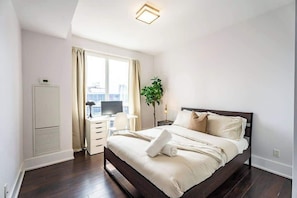 Cozy bedroom featuring a comfortable queen bed, designed for restful nights and a relaxing retreat. - Luxury Condo w/ CN Tower View, Workspace (Toronto)