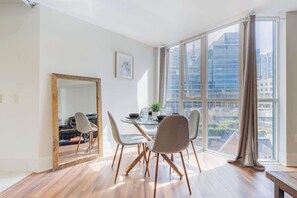 Dining space with seating, perfect for meals. - Modern Down Town Condo Near CN Tower w/ Fast WiFi (Toronto)