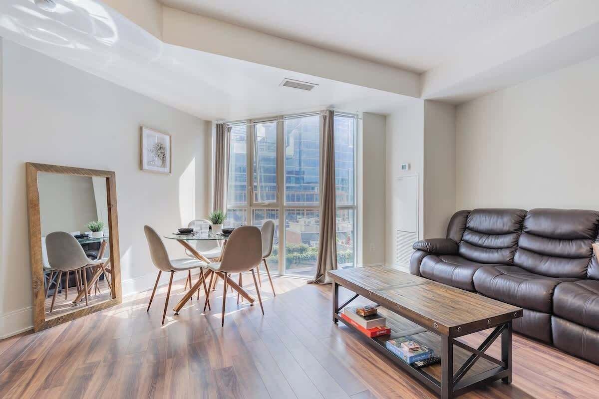 Bright and cozy living space with a Smart TV and comfortable seating.
