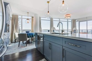 Fully equipped kitchen with sleek finishes and ample counter space. - Lakeview Condo | 2BR with Balcony & Free Parking (Toronto)