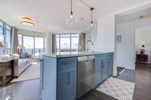 Fully equipped kitchen with sleek finishes and ample counter space. - Lakeview Condo | 2BR with Balcony & Free Parking (Toronto)