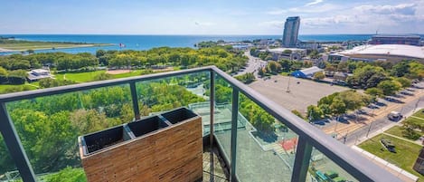 Private balcony with breathtaking views of the lake and city skyline.