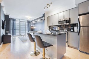 Modern kitchen fully equipped with everything you need for home-style meals. - 1BR Skyline Stay with Stylish Condo Near CN Tower (Toronto)