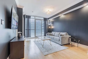 Bright and cozy space with a Smart TV and comfy seating to relax after exploring the city. - 1BR Skyline Stay with Stylish Condo Near CN Tower (Toronto)