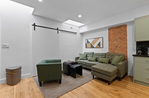 Cozy and inviting living space with comfy seating and a Smart TV for ultimate relaxation. - Chic 2BR Top-Floor Retreat w/Rooftop Near Subway (Toronto)