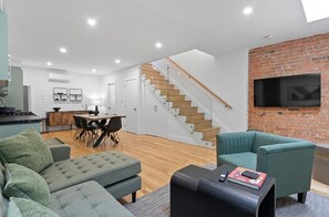 Cozy and inviting living space with comfy seating and a Smart TV for ultimate relaxation.