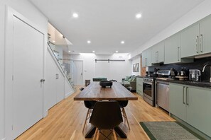 Gather around the spacious dining table, perfect for meals and meaningful conversations. - Chic 2BR Top-Floor Retreat w/Rooftop Near Subway (Toronto)