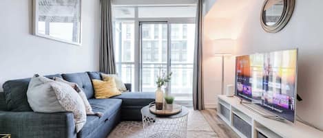 Kick back in our inviting living room with chic decor and ultra-comfy seating, your perfect spot to relax and catch your favorite show.